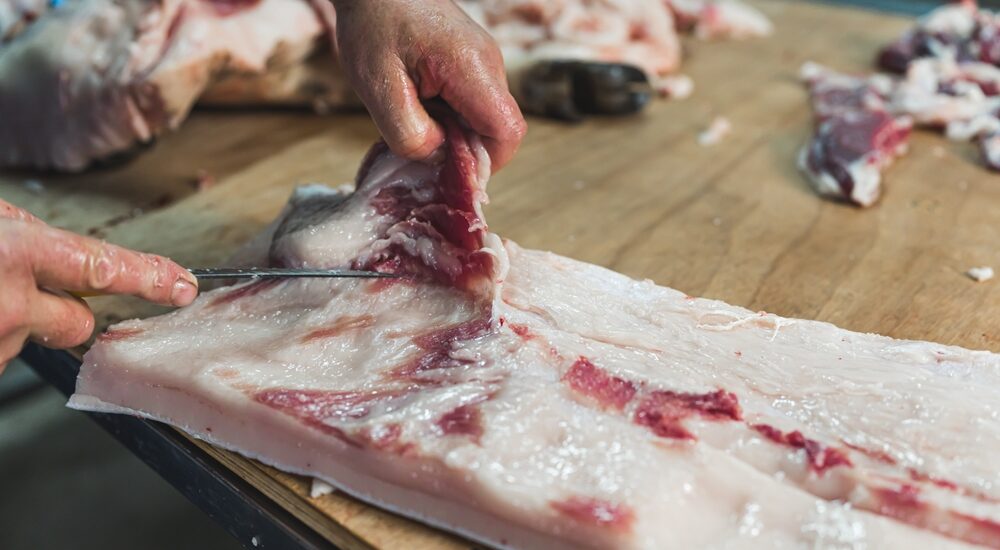Closeup,Of,The,Hands,Of,A,Butcher,Cutting,Slices,Of