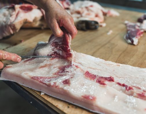 Closeup,Of,The,Hands,Of,A,Butcher,Cutting,Slices,Of