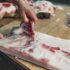 Closeup,Of,The,Hands,Of,A,Butcher,Cutting,Slices,Of